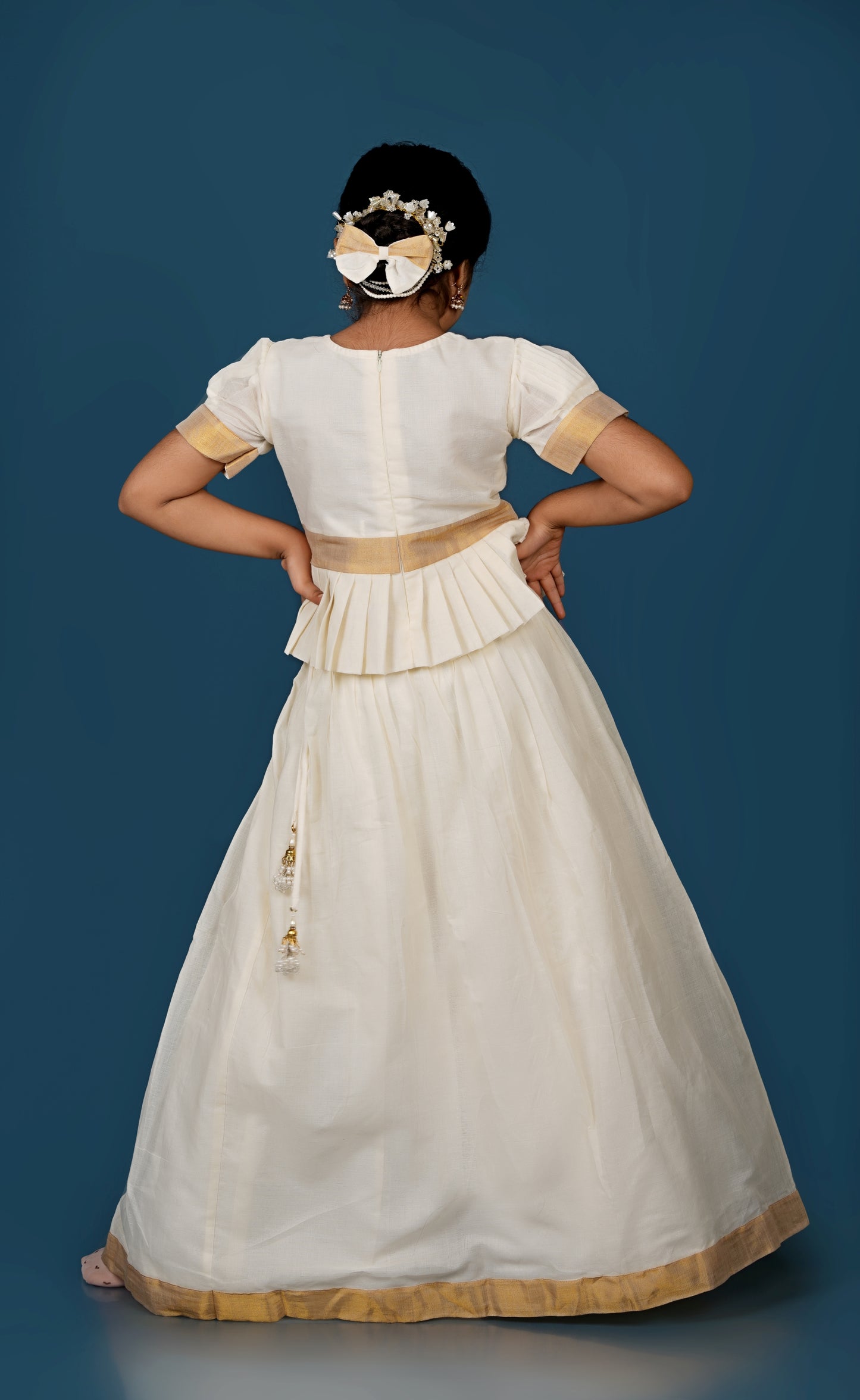 Glimmering Cream Peplum Top with Golden-Bordered Lehenga Set