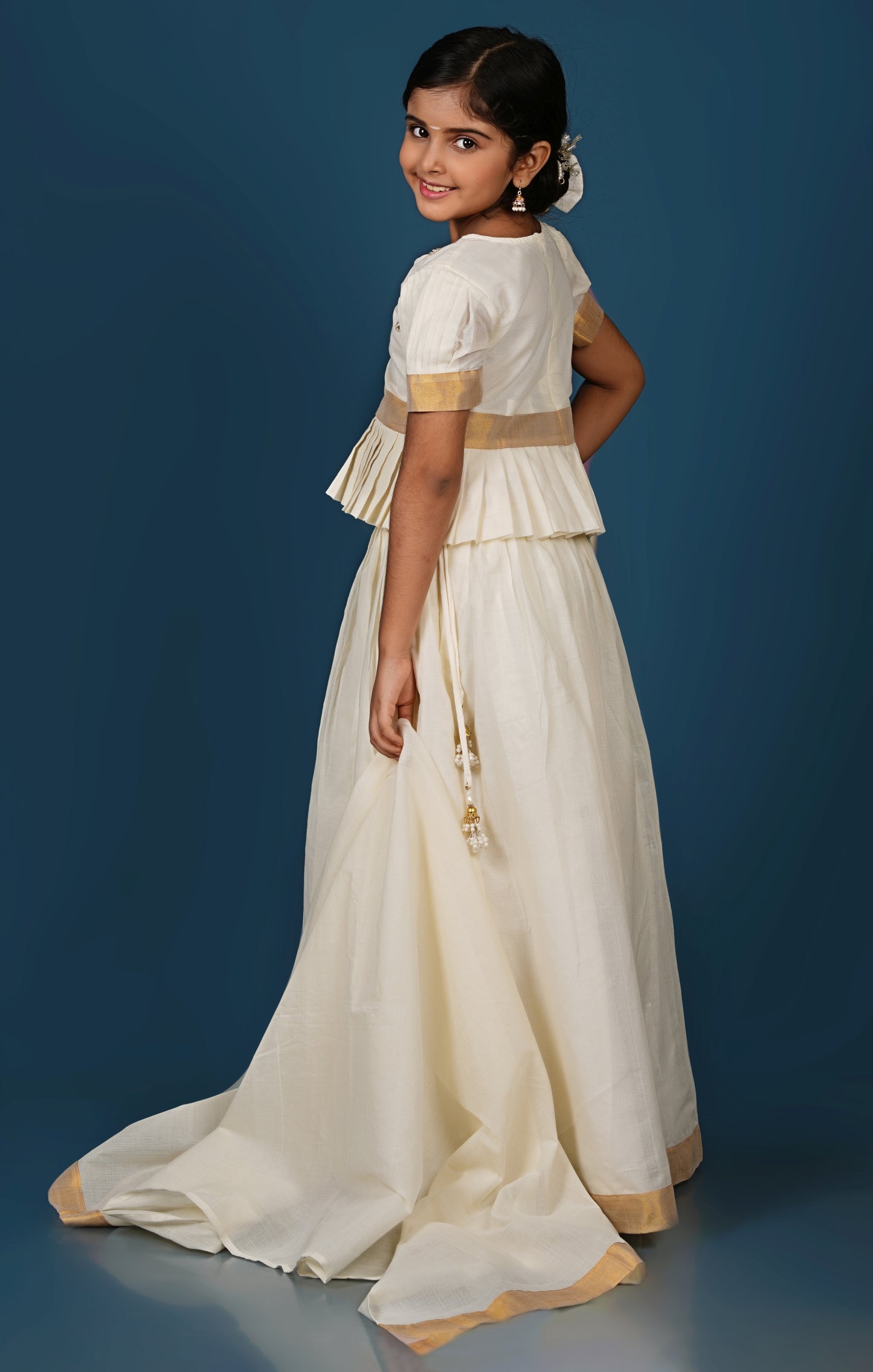 Glimmering Cream Peplum Top with Golden-Bordered Lehenga Set